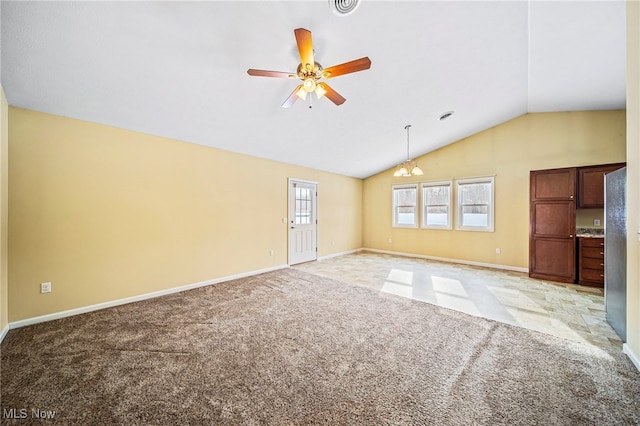 unfurnished living room featuring vaulted ceiling, ceiling fan with notable chandelier, and light colored carpet