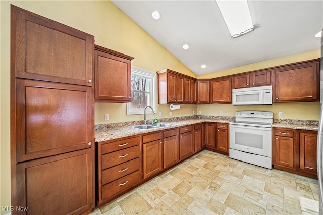 kitchen with vaulted ceiling, sink, light stone counters, and white appliances