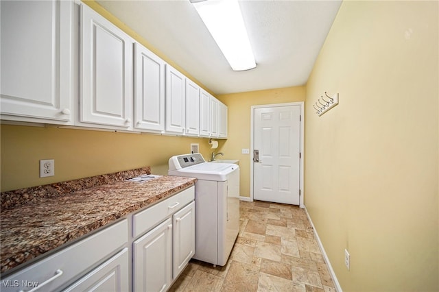 clothes washing area featuring sink, washer / dryer, and cabinets