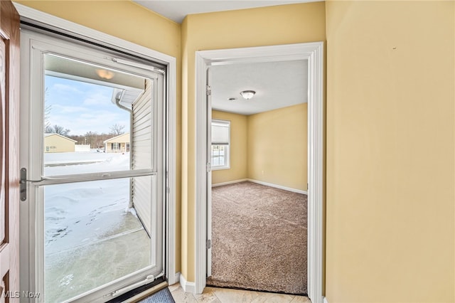 entryway featuring light carpet