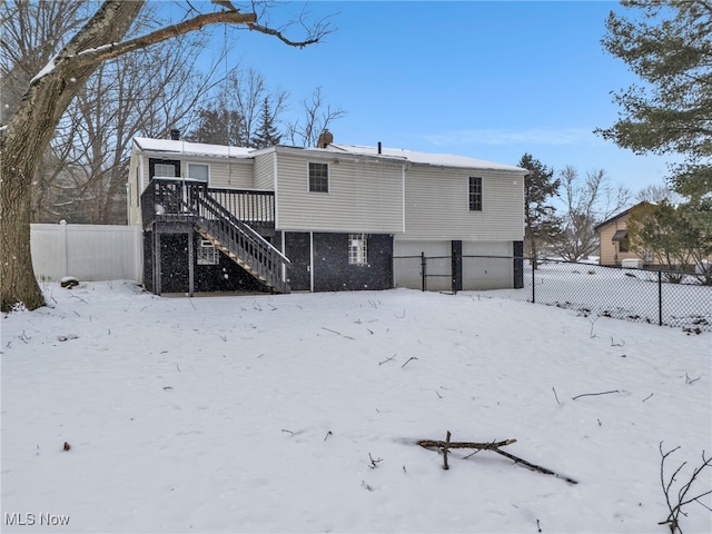 snow covered property featuring a wooden deck