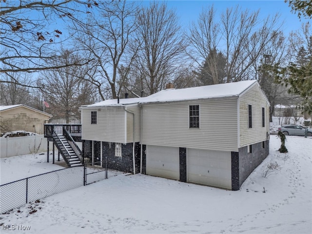 exterior space with a garage and a wooden deck