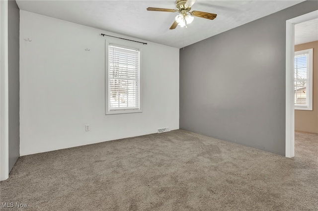 unfurnished room with light carpet and ceiling fan