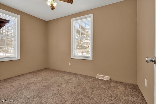 spare room featuring carpet floors and ceiling fan