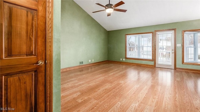 spare room featuring ceiling fan, lofted ceiling, and light hardwood / wood-style flooring