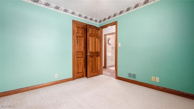 unfurnished bedroom featuring light colored carpet