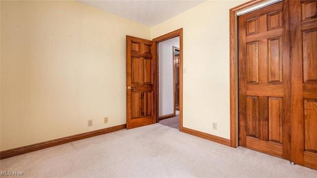 unfurnished bedroom featuring light carpet