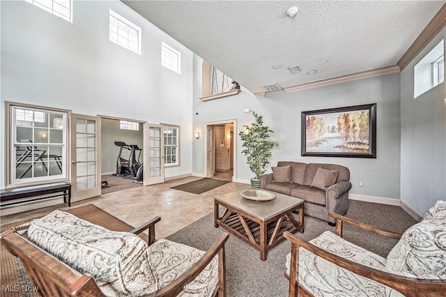 tiled living room featuring french doors, a textured ceiling, and a high ceiling