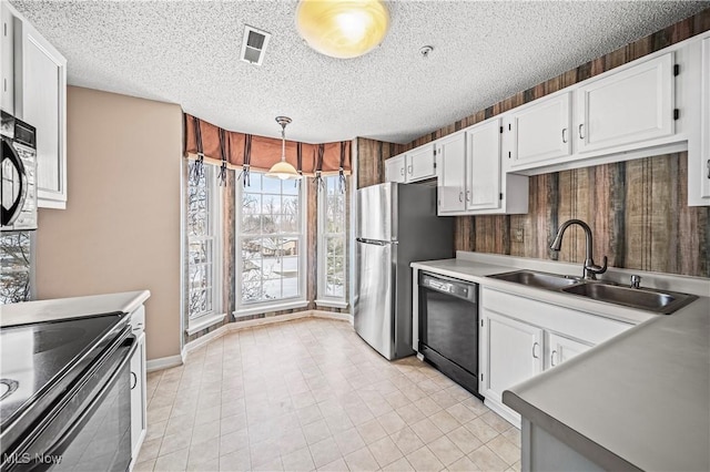 kitchen with white cabinetry, decorative light fixtures, sink, and black appliances