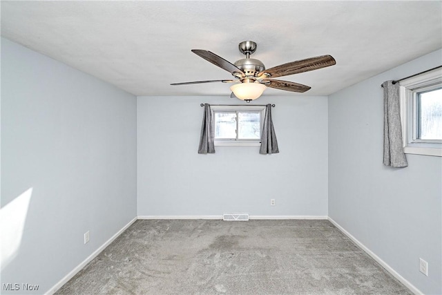 carpeted spare room with ceiling fan