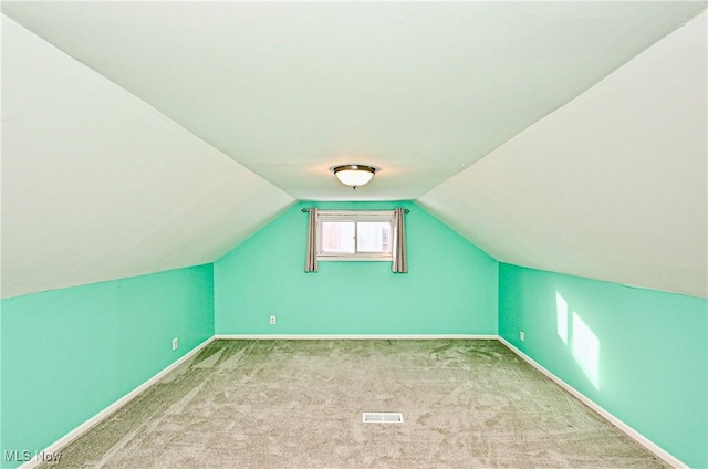 bonus room with lofted ceiling and carpet floors