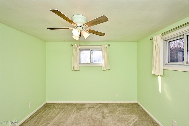 empty room featuring light carpet and ceiling fan