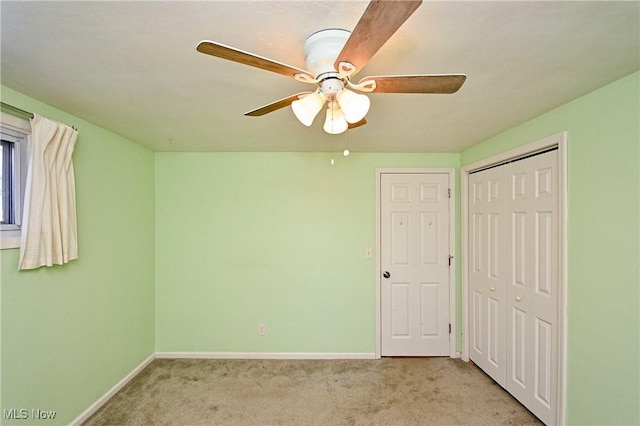 unfurnished bedroom featuring light colored carpet, a closet, and ceiling fan