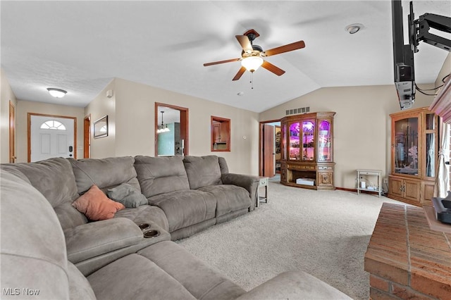 carpeted living room with ceiling fan and lofted ceiling