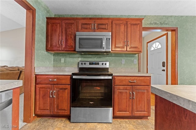 kitchen with vaulted ceiling and appliances with stainless steel finishes