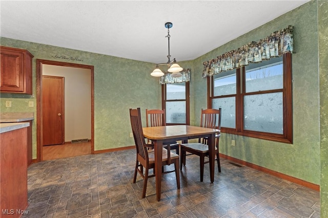 dining area featuring a notable chandelier