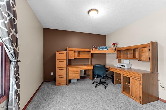 home office with light colored carpet and a textured ceiling