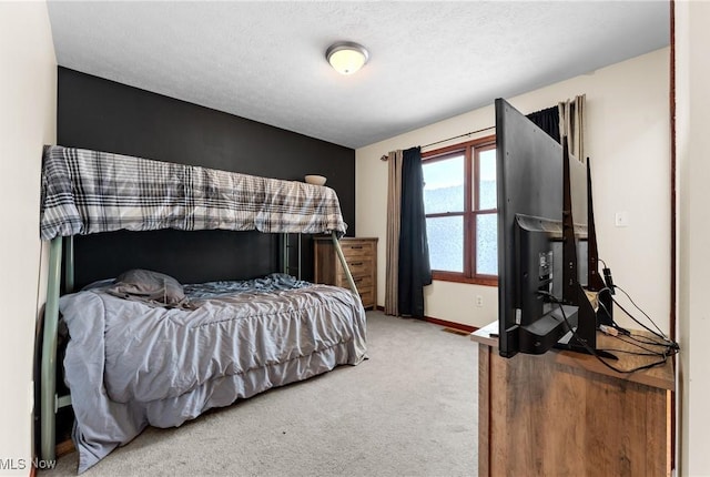 bedroom with carpet flooring and a textured ceiling