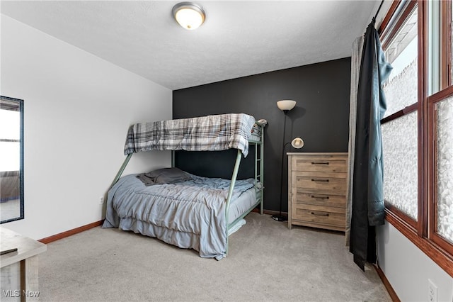 bedroom featuring multiple windows and carpet