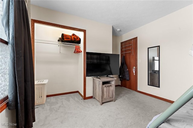 bedroom featuring light colored carpet and a closet