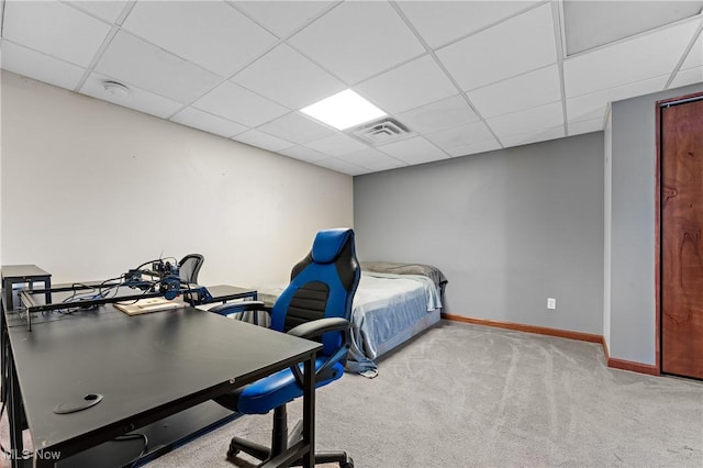 carpeted bedroom featuring a paneled ceiling