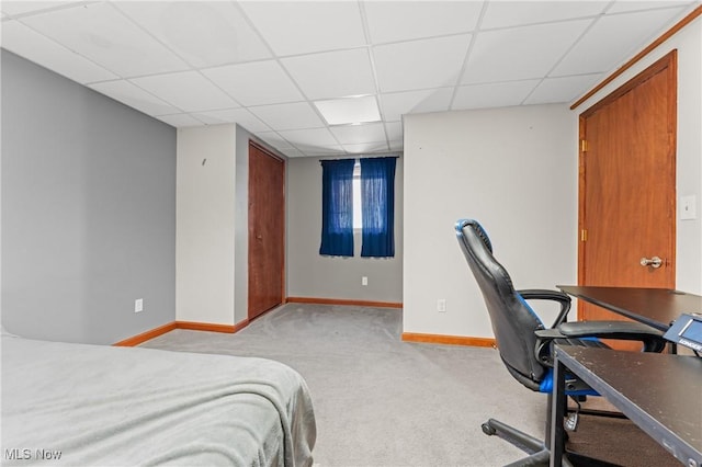 carpeted bedroom with a drop ceiling