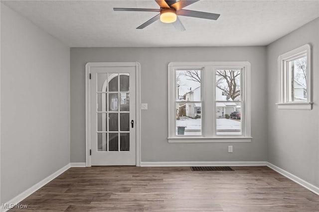 unfurnished room featuring hardwood / wood-style floors, a textured ceiling, and ceiling fan