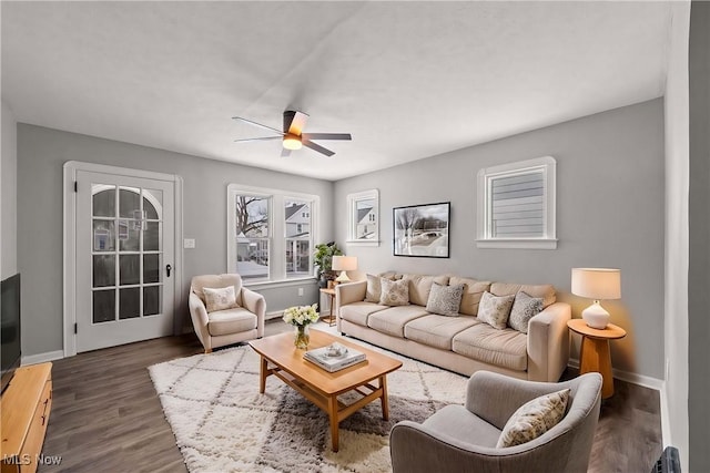 living room featuring dark hardwood / wood-style flooring and ceiling fan