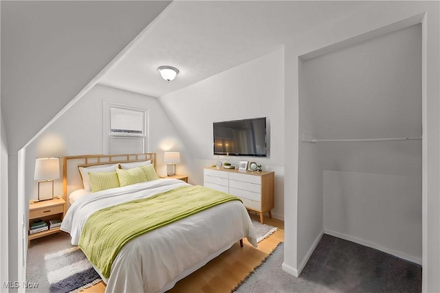 bedroom featuring lofted ceiling and carpet floors