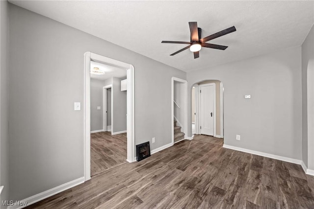 unfurnished bedroom with dark hardwood / wood-style flooring and ceiling fan