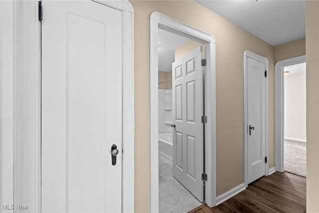 hallway with wood-type flooring