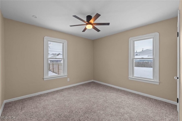 carpeted empty room featuring ceiling fan