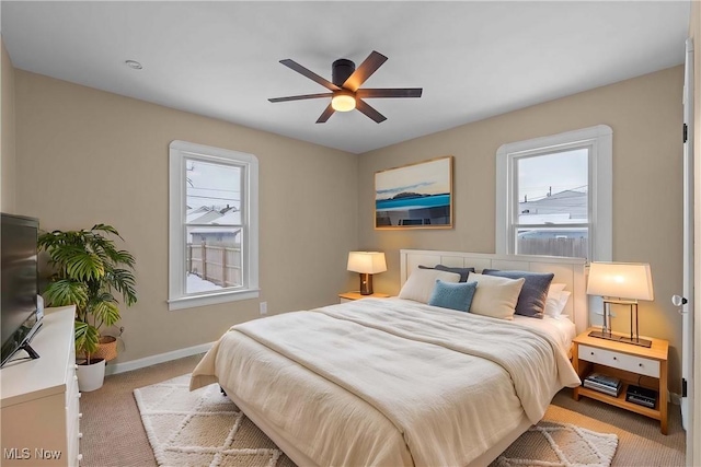 bedroom featuring ceiling fan and light carpet