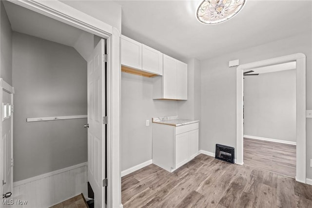 laundry room featuring light wood-type flooring