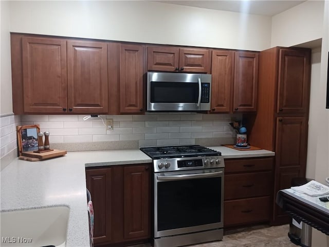 kitchen featuring tasteful backsplash, stainless steel appliances, and sink