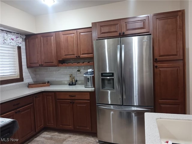 kitchen featuring backsplash and stainless steel fridge