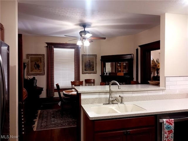 kitchen featuring sink, stainless steel dishwasher, ceiling fan, and kitchen peninsula