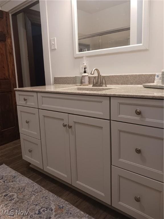 bathroom featuring vanity and hardwood / wood-style floors