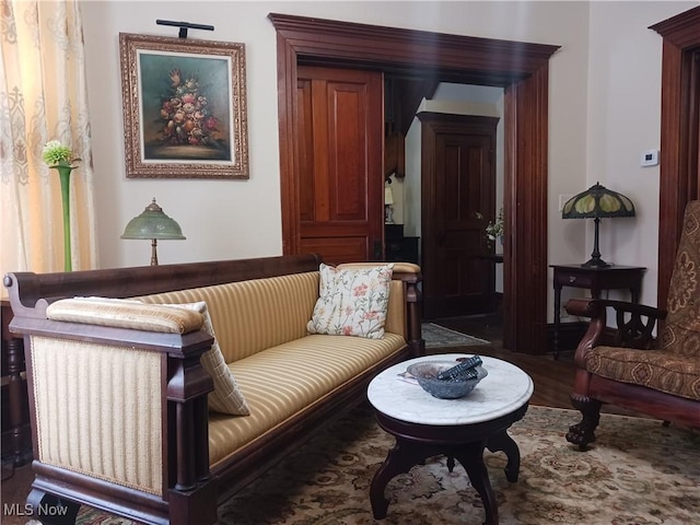 sitting room featuring dark wood-type flooring