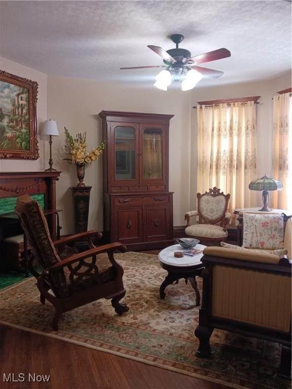 interior space featuring dark hardwood / wood-style flooring, ceiling fan, and a textured ceiling