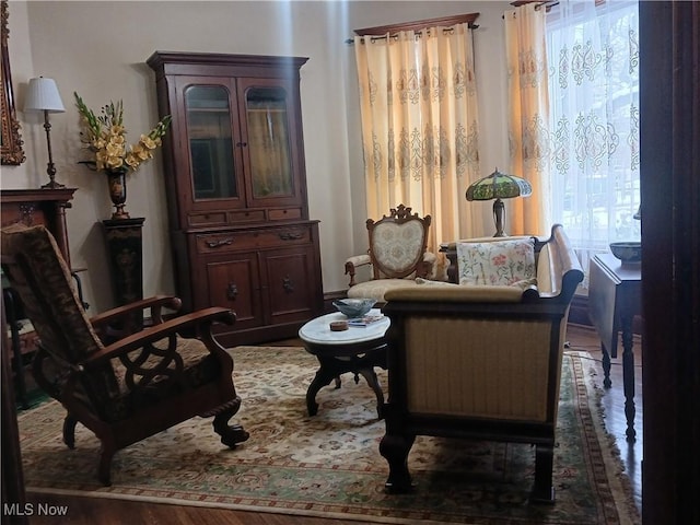 sitting room with dark hardwood / wood-style flooring