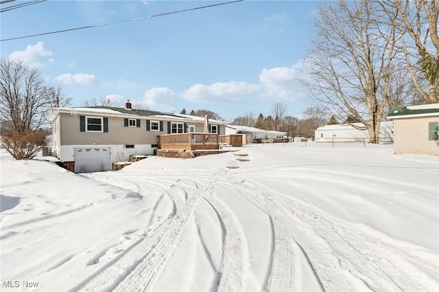 view of front facade featuring a garage and a deck