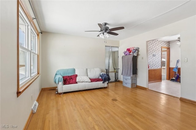 sitting room with ceiling fan and light wood-type flooring