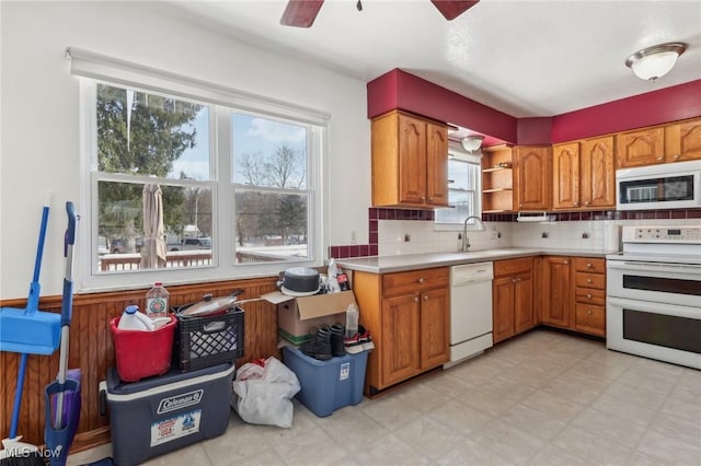 kitchen featuring tasteful backsplash, plenty of natural light, sink, and white appliances