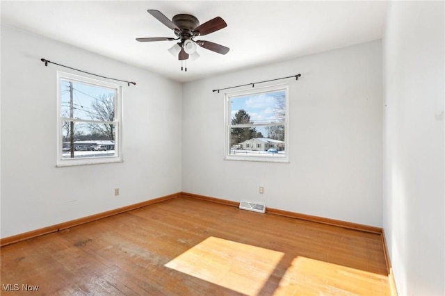 unfurnished room featuring hardwood / wood-style floors and ceiling fan