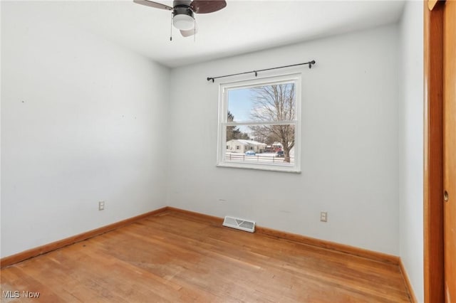 unfurnished room with ceiling fan and hardwood / wood-style floors