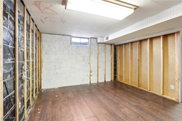 basement featuring dark wood-type flooring