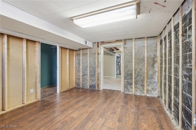 basement featuring hardwood / wood-style floors