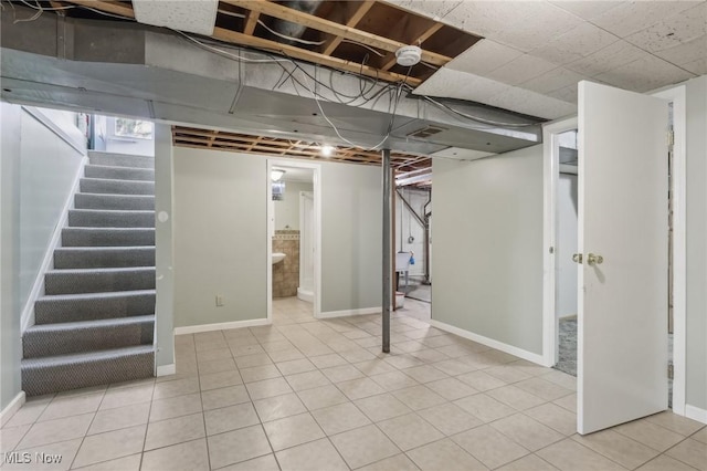 basement featuring light tile patterned flooring