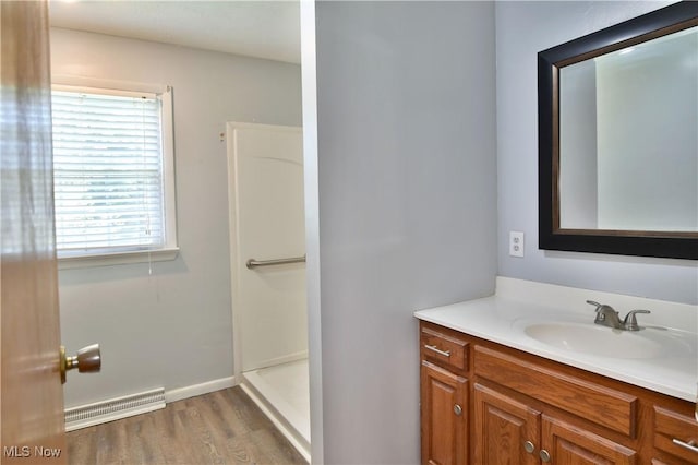 bathroom with vanity, hardwood / wood-style floors, and a shower